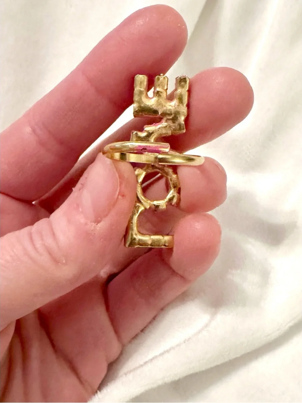 Tova LOVE statement Ring featuring pink crystals set in a gold-tone band